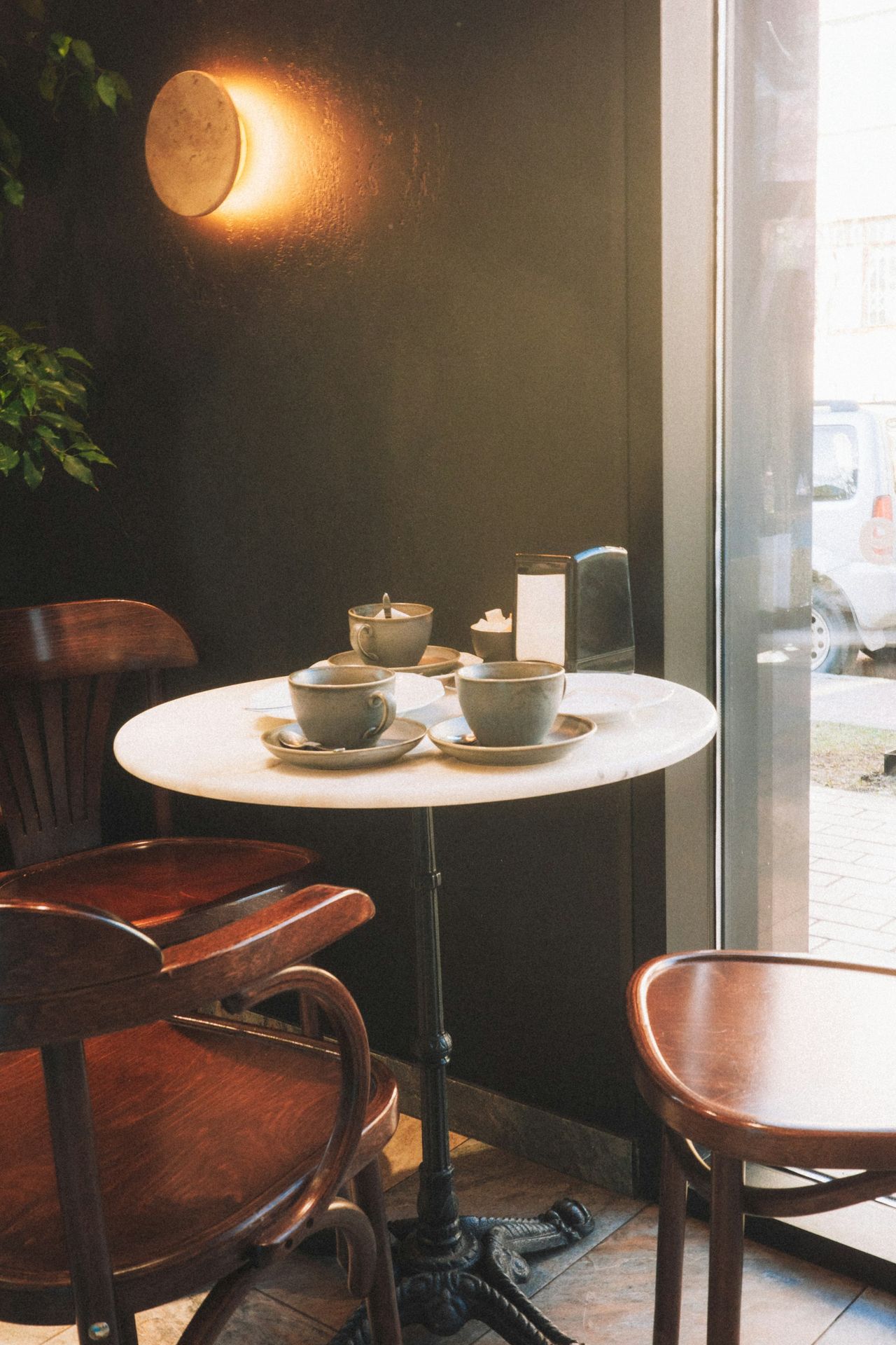 Two cups of coffee on a small marble table